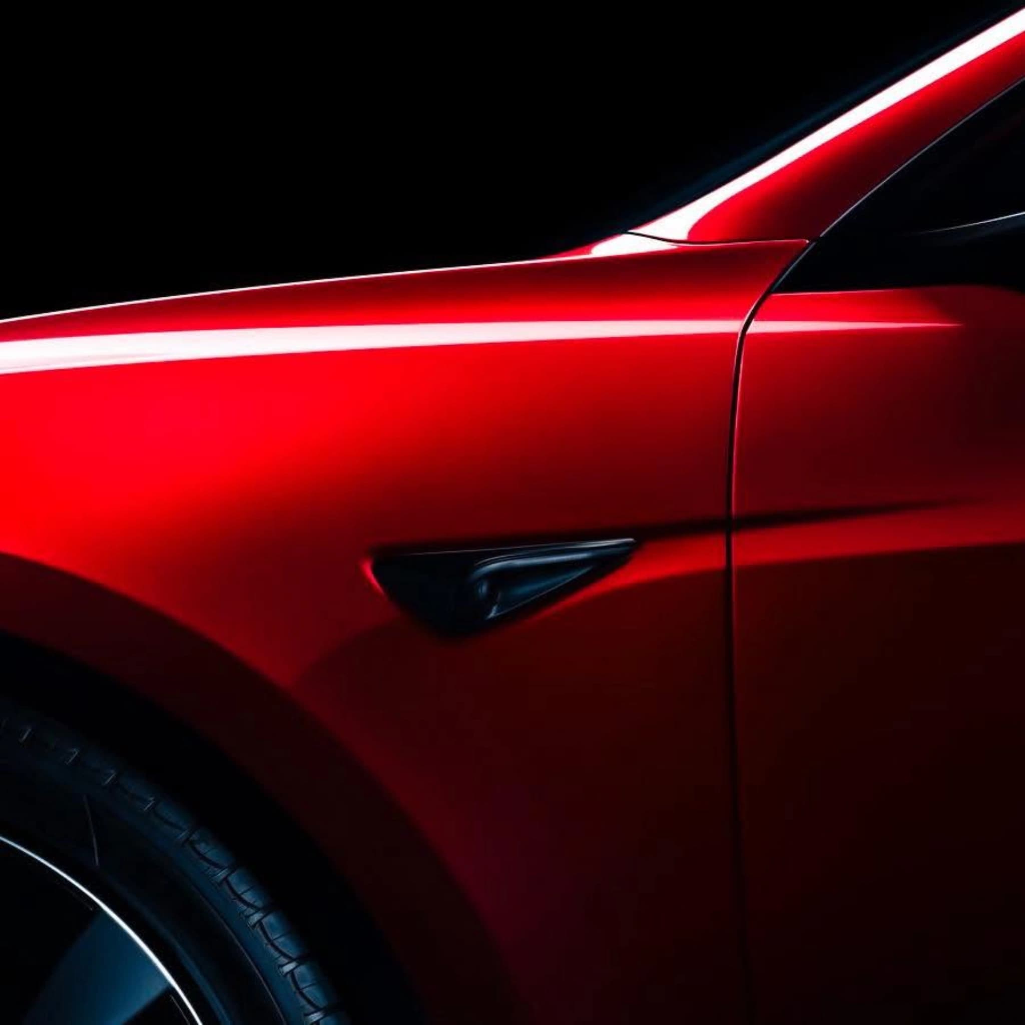 red tesla front fender detail