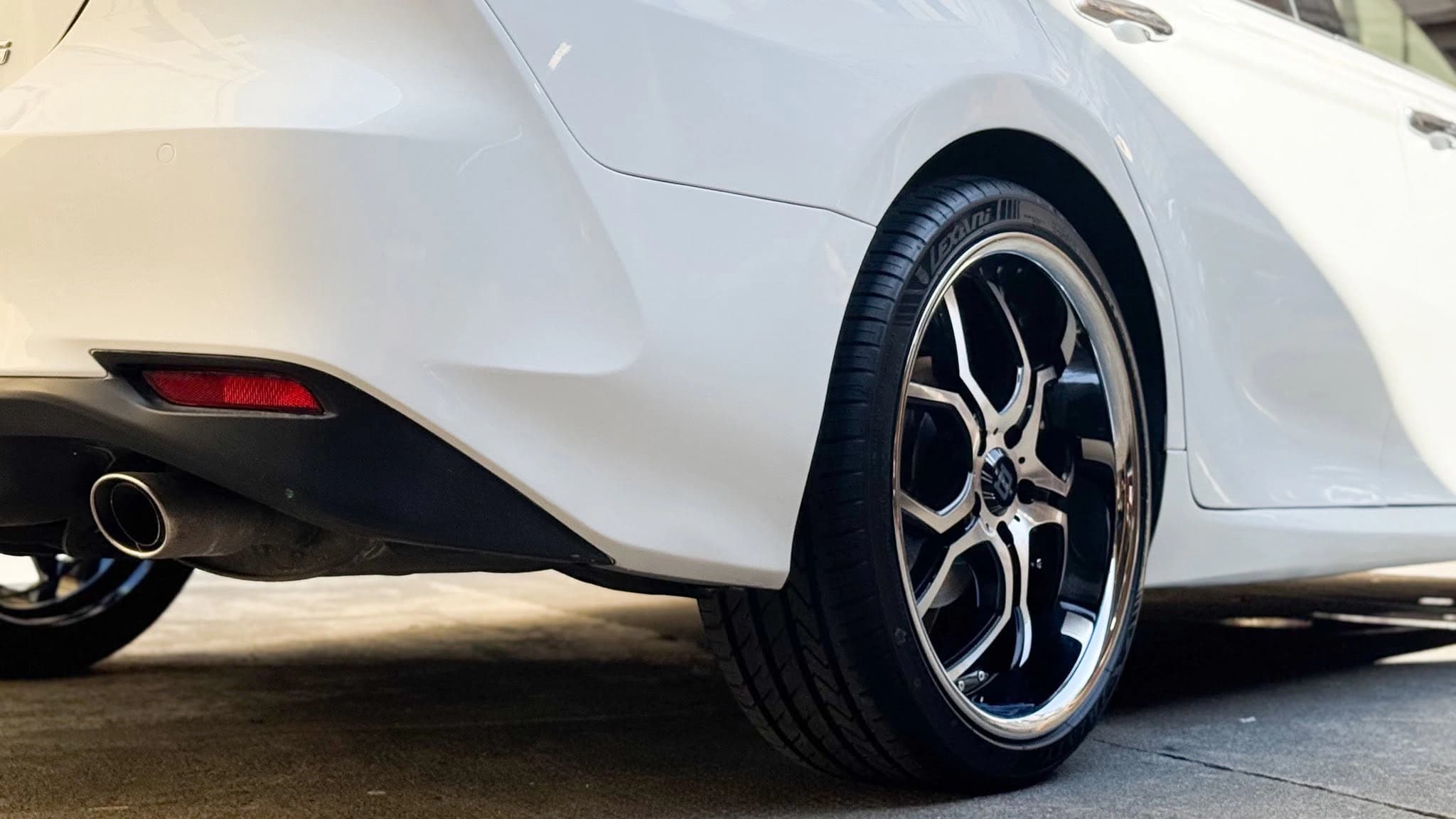 white sedan rear wheel detail
