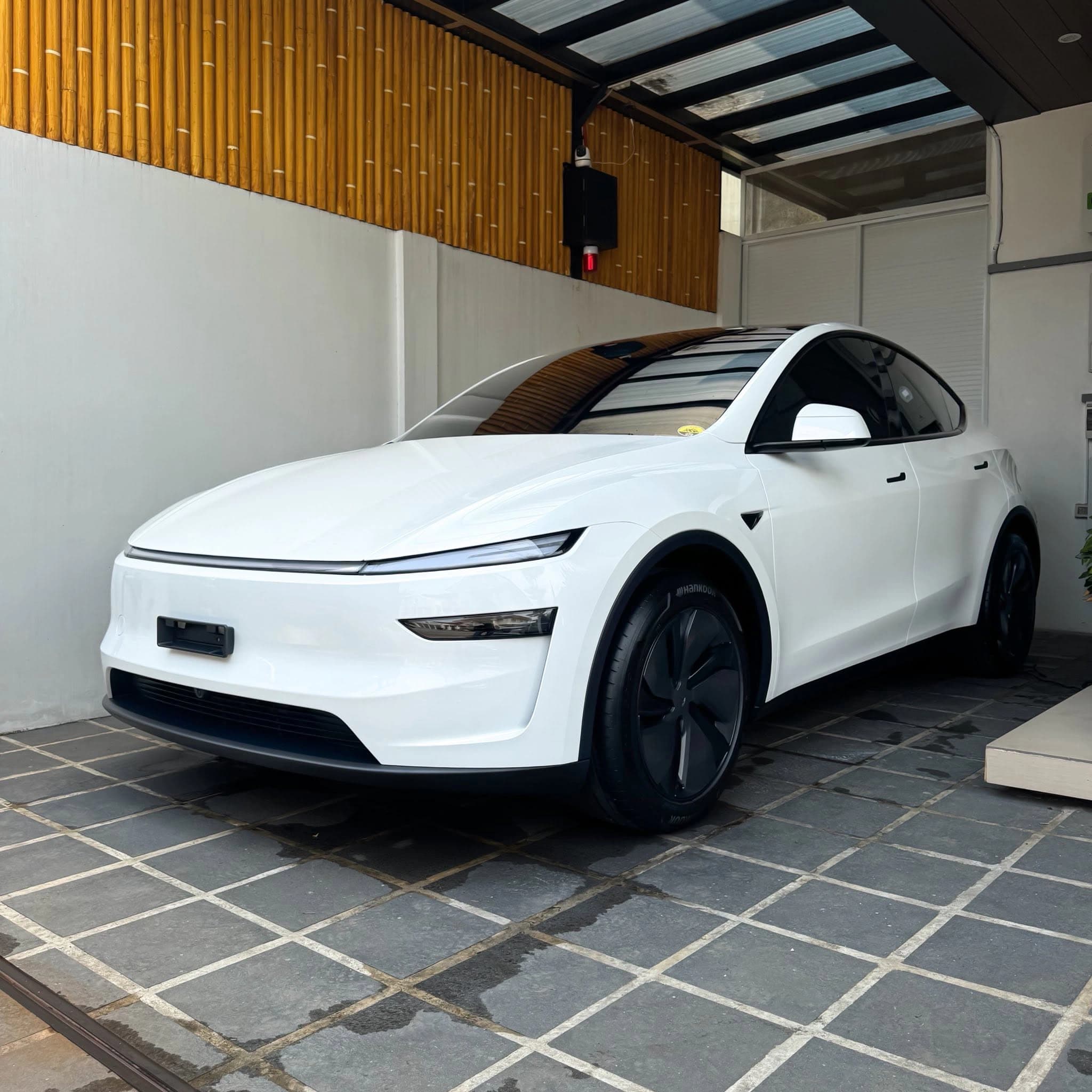 white tesla model y front angle