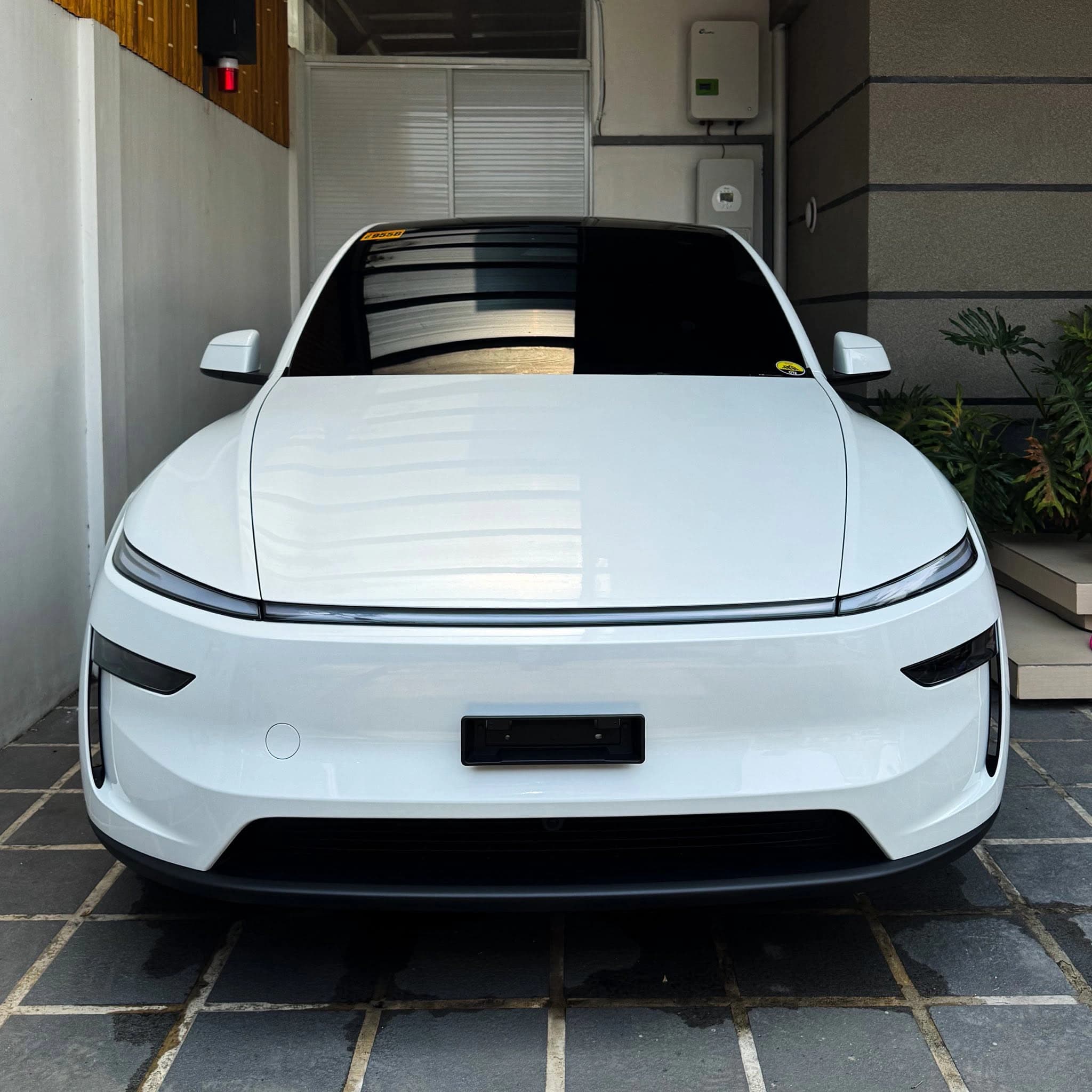 white tesla model y front view