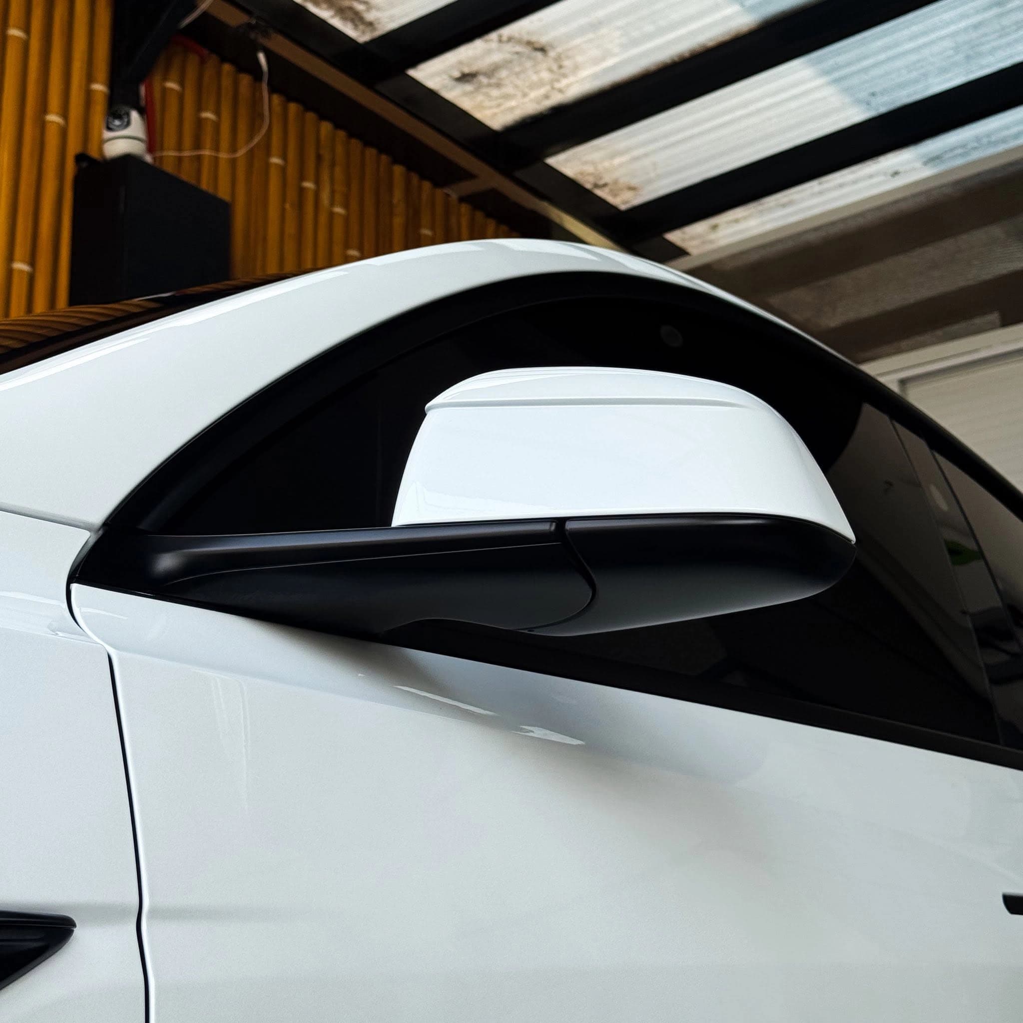 white tesla model y side mirror detail